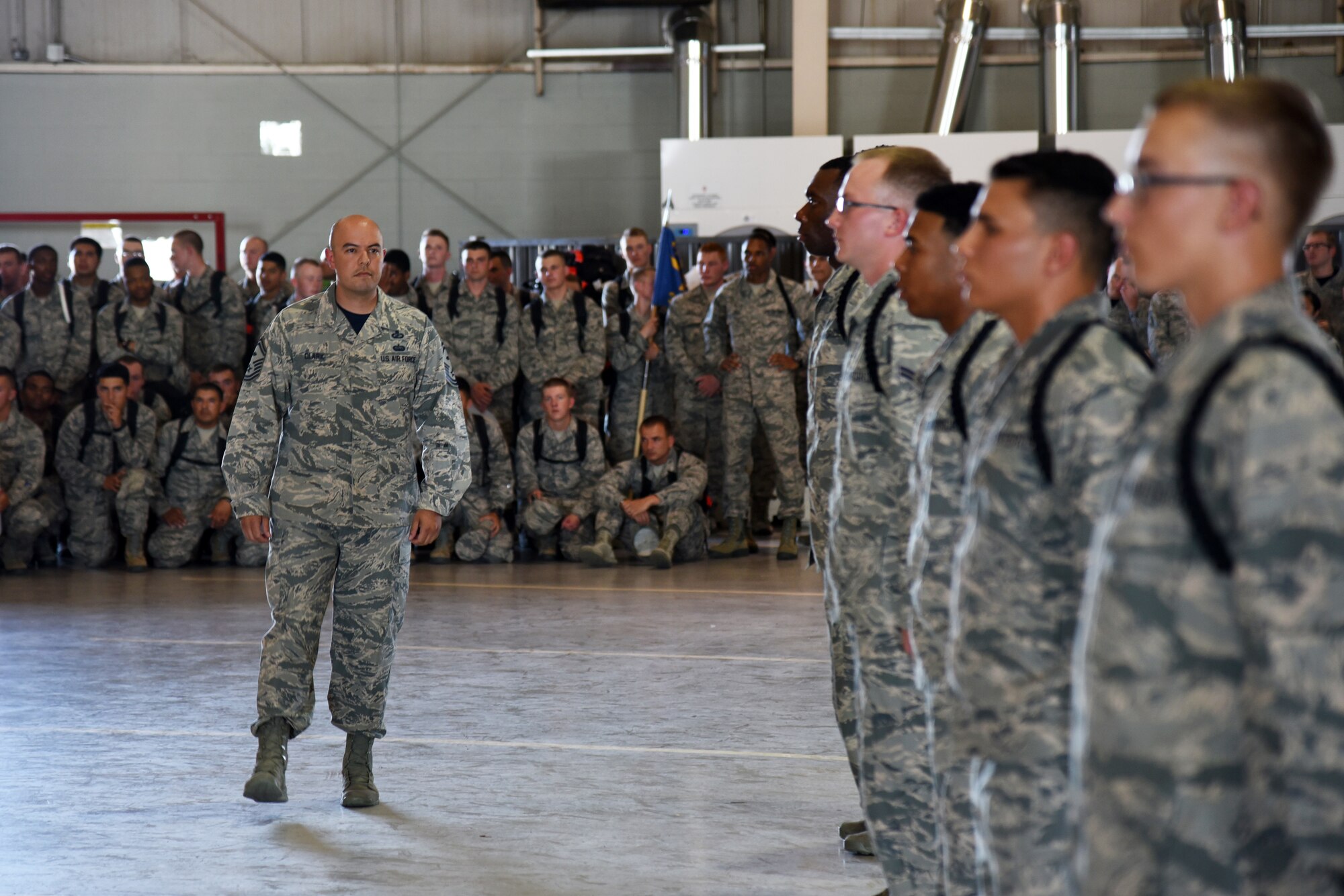 U.S. Air Force Senior Master Sgt. David Clark, 315th Training Squadron first sergeant, judges during the individual drill portion of the 17th Training Group drill competition at the Louis F. Garland Department of Defense Fire Academy on Goodfellow Air Force Base, Texas, June 22, 2018. During the individual drill, trainees received a series of commands with individuals becoming disqualified for performing the wrong movement. (U.S. Air Force photo by Staff Sgt. Joshua Edwards/Released)