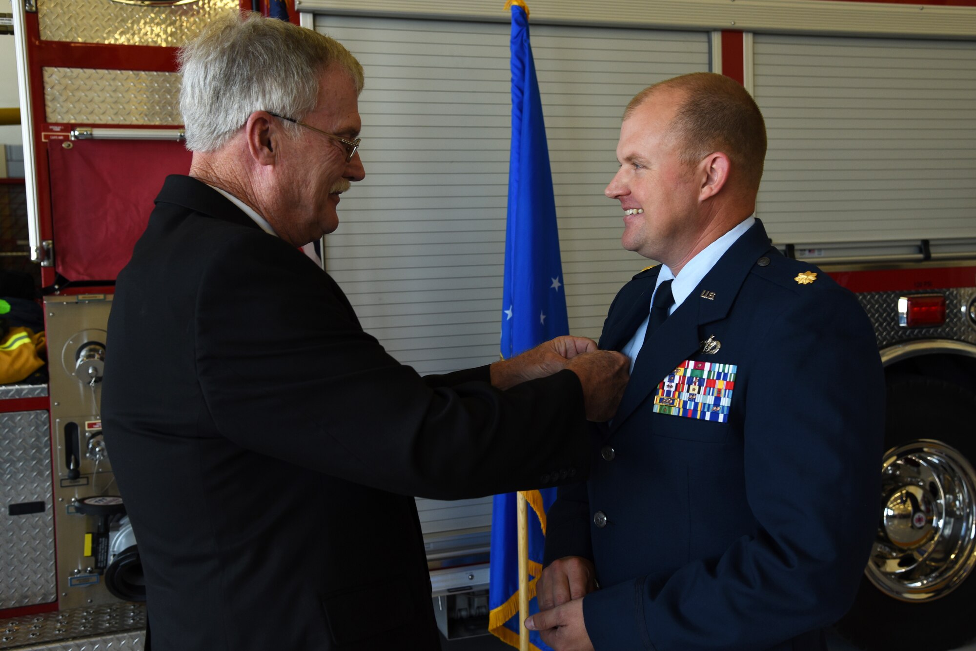 U.S. Air Force Maj. Nicholas Anderson, 17th Civil Engineer Squadron commander, receives his commander’s pin from his father during the 17th CES Assumption of Command at the fire department on Goodfellow Air Force Base, Texas, June 22, 2018. The pin signifies that individual holds the position of commander of a squadron, group, wing or major command. (U.S. Air Force photo by Staff Sgt. Joshua Edwards/Released)
