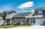 Photovoltaic (PV) panels installed on the front side of two houses in the Dover Family Housing community absorb sunlight to generate electricity May 11, 2018, at Dover Air Force Base, Del. Electricity generated by PV panels is transmitted to the electrical grid, not the individual house or houses. Occupants will not see a reduction in their electricity bill. (U.S. Air Force photo by Roland Balik)