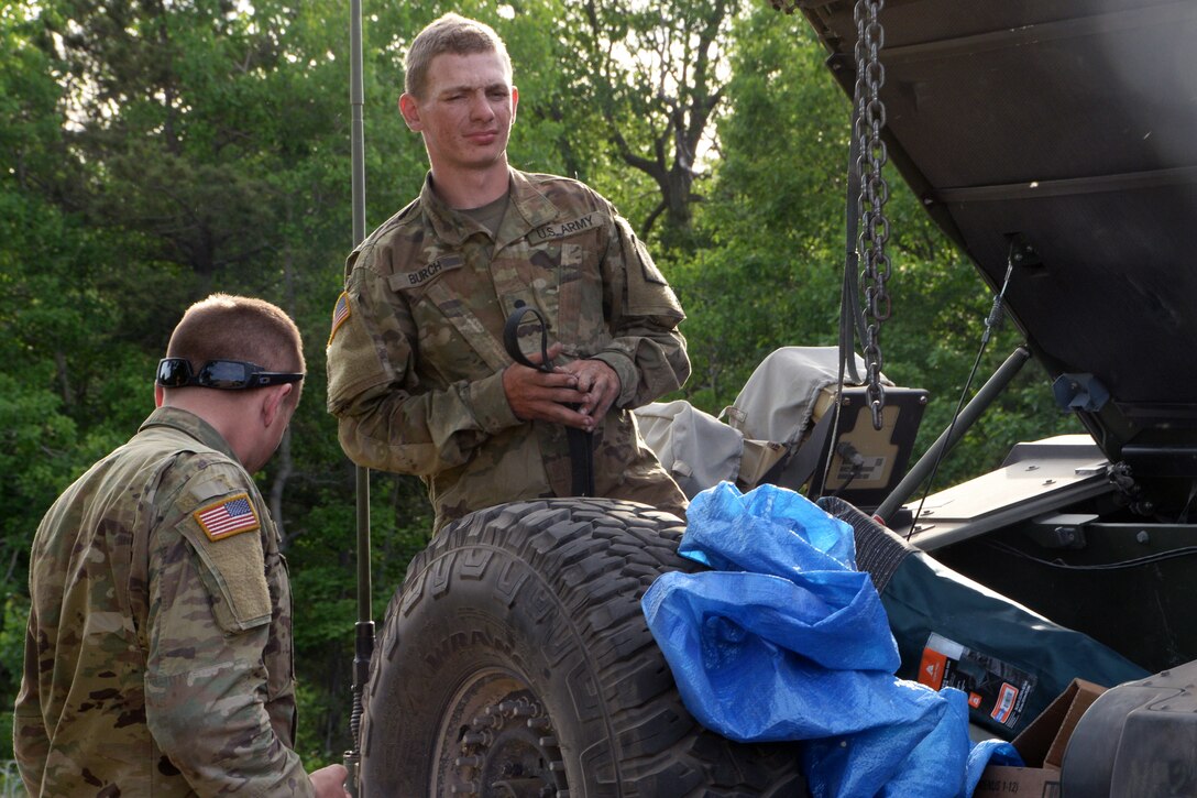A soldier cleans out a Humvee after conducting lane exercises.