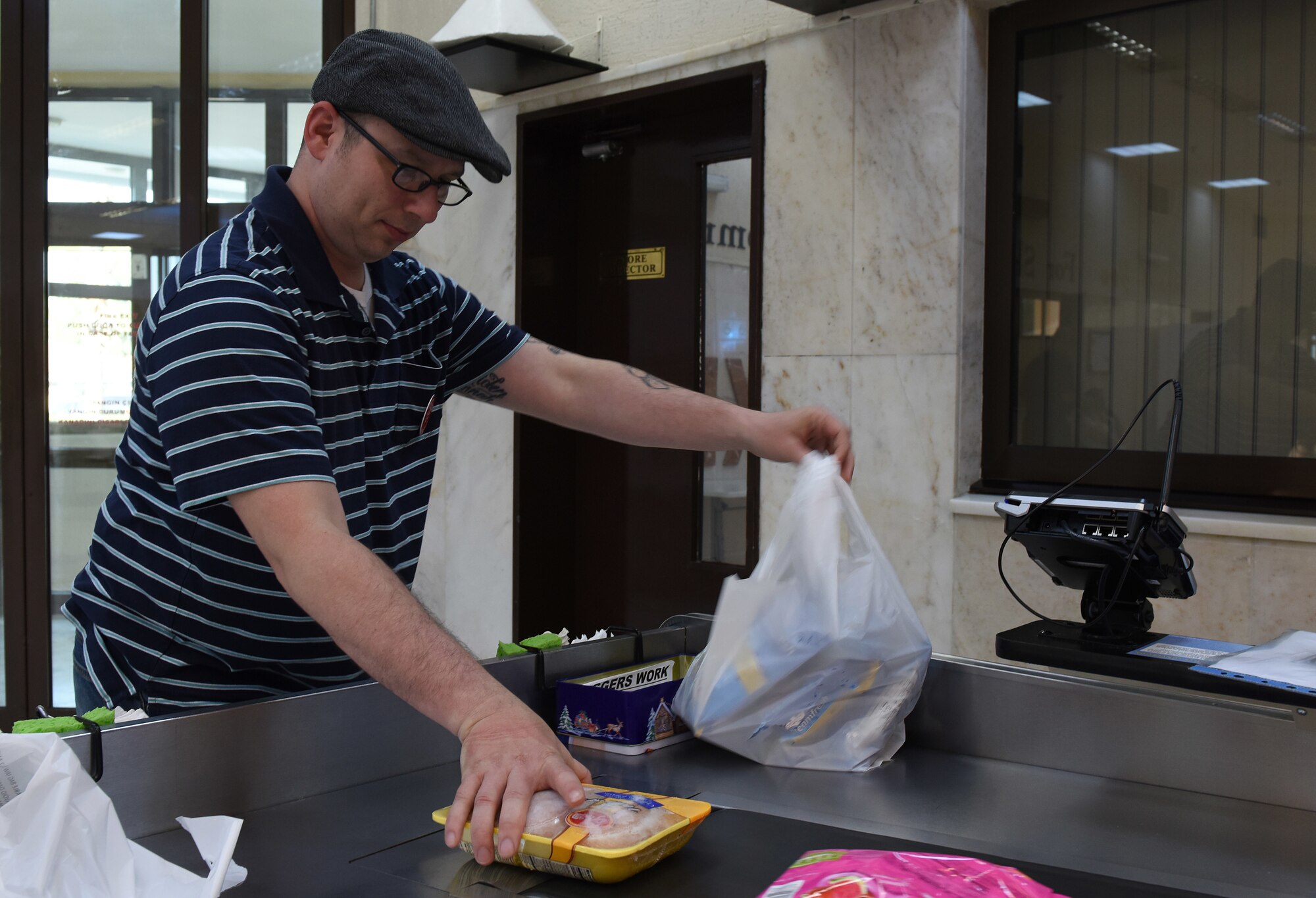 U.S. Air Force Master Sgt. Travis Lacy, 39th Force Support Squadron superintendent of manpower, organization and continuous process improvement, bags groceries at the Commissary at Incirlik Air Base, Turkey, June 19, 2018.