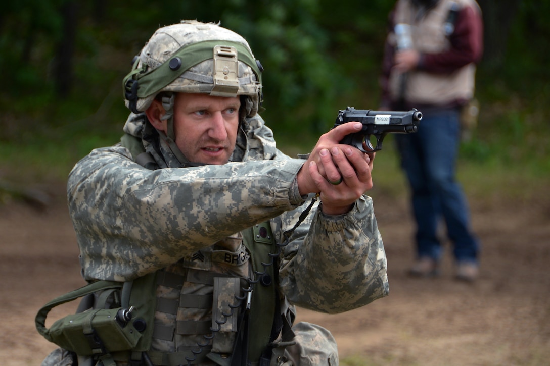 A military policeman prepares to fire his M9 pistol during weapons qualification.