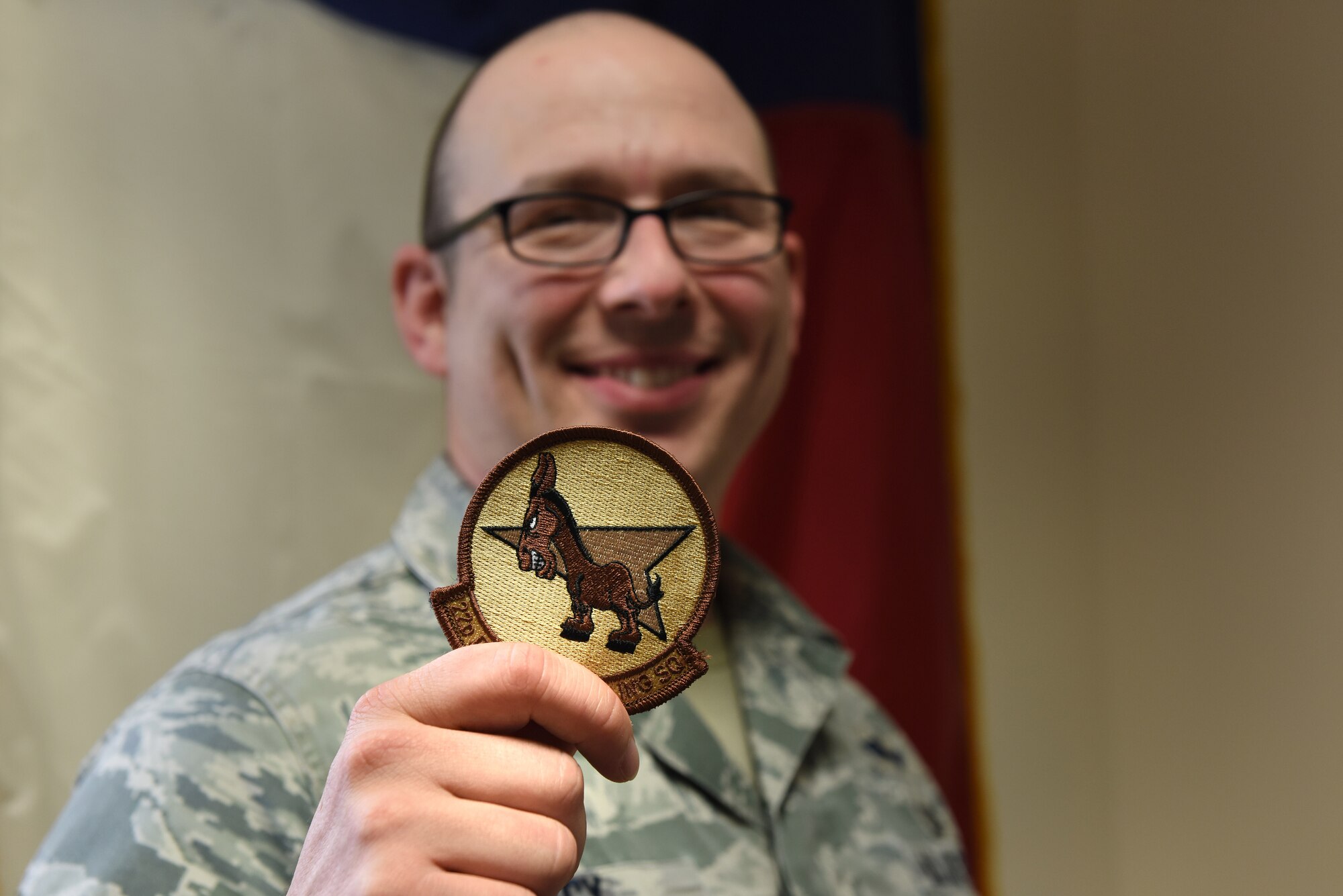 U.S. Air Force Master Sgt. Travis Lacy, 39th Force Support Squadron superintendent of manpower, organization and continuous process improvement, holds a 22nd Expeditionary Air Refueling Squadron patch at Incirlik Air Base, Turkey, June 19, 2018.