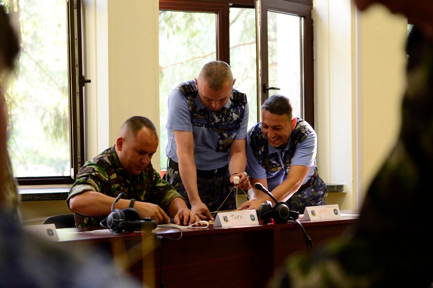 Three Romanian Air Force students participate in a strategic thinking exercise during the first-ever senior noncom missed officer mobile education course June 8 to 22, 2018, at Boboc Air Base, in Buzău, Romania. The SNCOA mobile training team partnered with the Inter-European Air Forces Academy to provide a two-week course, condensed from the full five-week course held at Maxwell Air Force Base- Gunter Annex, Alabama. (U.S. Air Force photo by Tech. Sgt. Staci Kasischke)