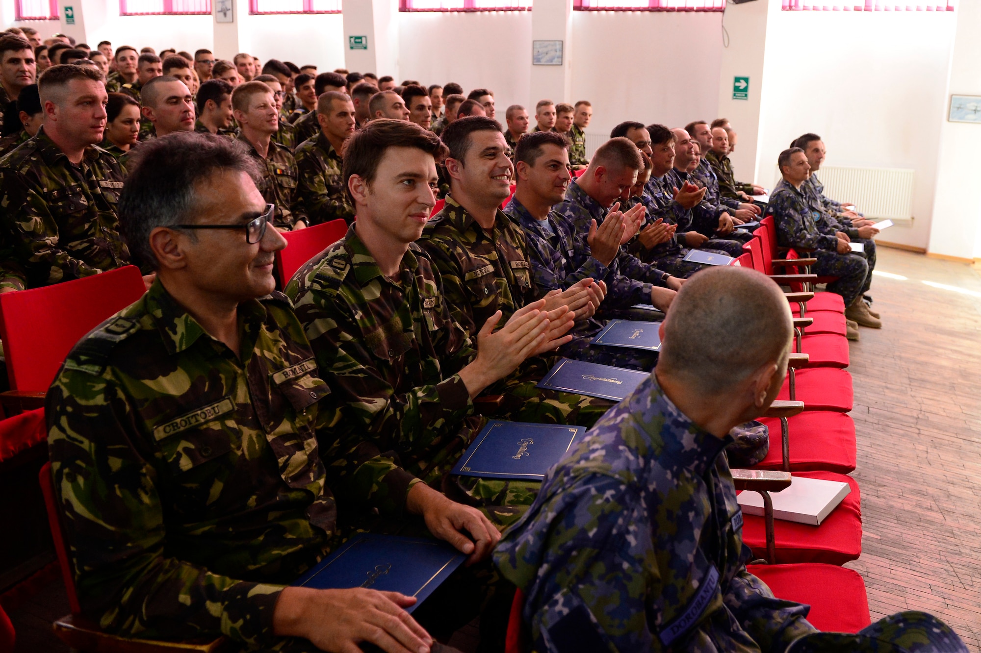Romanian students celebrate after graduating from the first-ever senior noncommissioned officer mobile education course June 8 to 22, 2018, at Boboc Air Base, in Buzău, Romania. The SNCOA mobile training team partnered with the Inter-European Air Forces Academy to provide a two-week course, condensed from the full five-week course held at Maxwell Air Force Base- Gunter Annex, Alabama. (U.S. Air Force photo by Tech. Sgt. Staci Kasischke)