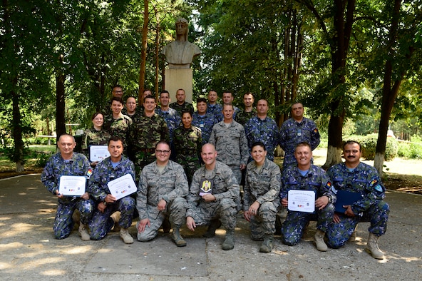 U.S. Air Force Senior Noncommissioned Officer Academy instructors pose with Romanian Air Force students after the first-ever senior noncommissioned officer mobile education course graduation June 8 to 22, 2018, at Boboc Air Base, in Buzău, Romania. The SNCOA mobile training team partnered with the Inter-European Air Forces Academy to provide a two-week course, condensed from the full five-week course held at Maxwell Air Force Base- Gunter Annex, Alabama. (U.S. Air Force photo by Tech. Sgt. Staci Kasischke)