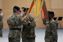 Soldiers passing flag