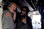 Members of the Rhode Island National Guard look out from the back of an airplane