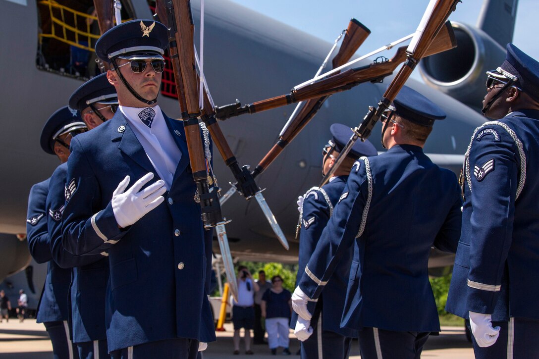 The Air Force Honor Guard Drill Team performs weapon tosses and exchanges.