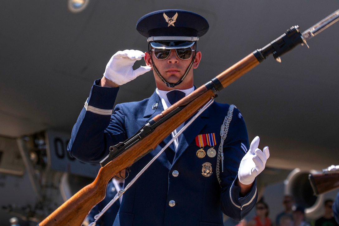 An Air Force airman assigned to the Honor Guard Drill Team demonstrates a complex rifle maneuver.