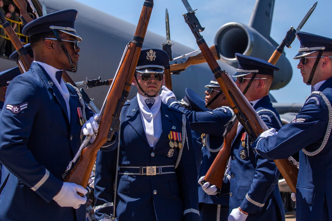 The Air Force Honor Guard Drill Team performs in front of visitors.