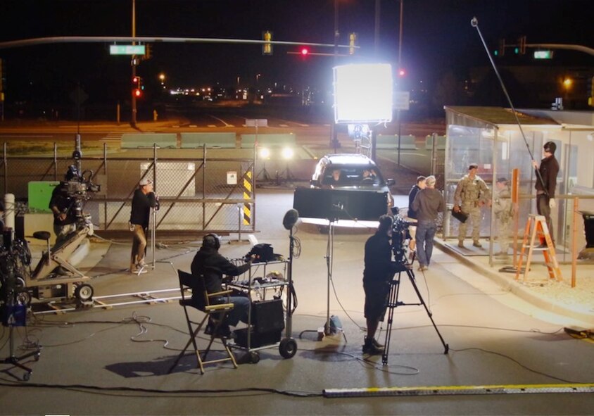 A film crew shoots a nighttime scene at Buckley Air Force Base, Colo., Sept. 24, 2015. Members of the Center of Excellence for Medical Multimedia regularly work with film production professionals to create training and education videos for the Department of Defense. (Courtesy photo)