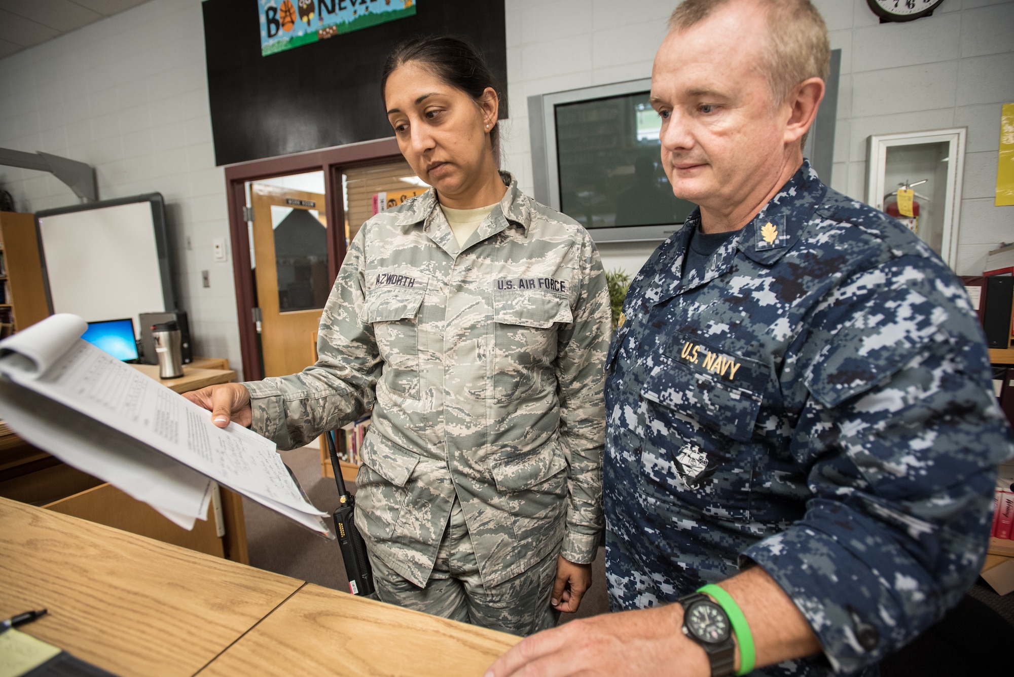 U.S. Air Force Master Sgt. Nikki Nazworth (left), from the Kentucky Air National Guard’s 123rd Airlift Wing, discusses patient care with U.S. Navy Lt. Cmdr. Frank McKeown, a registered nurse from Expeditionary Medical Facility Bethesda in Maryland, at a health-care clinic being run by the Air Guard and U.S. Navy Reserve at Owsley County High School in Booneville, Ky., June 20, 2018. The clinic is one of four that comprised Operation Bobcat, a 10-day mission to provide military medical troops with crucial training in field operations and logistics while offering no-cost health care to the residents of Eastern Kentucky. The clinics, which operated from June 15-24, offered non-emergent medical care; sports physicals; dental cleanings, fillings and extractions; eye exams and no-cost prescription eye glasses. (U.S. Air National Guard photo by Lt. Col. Dale Greer)