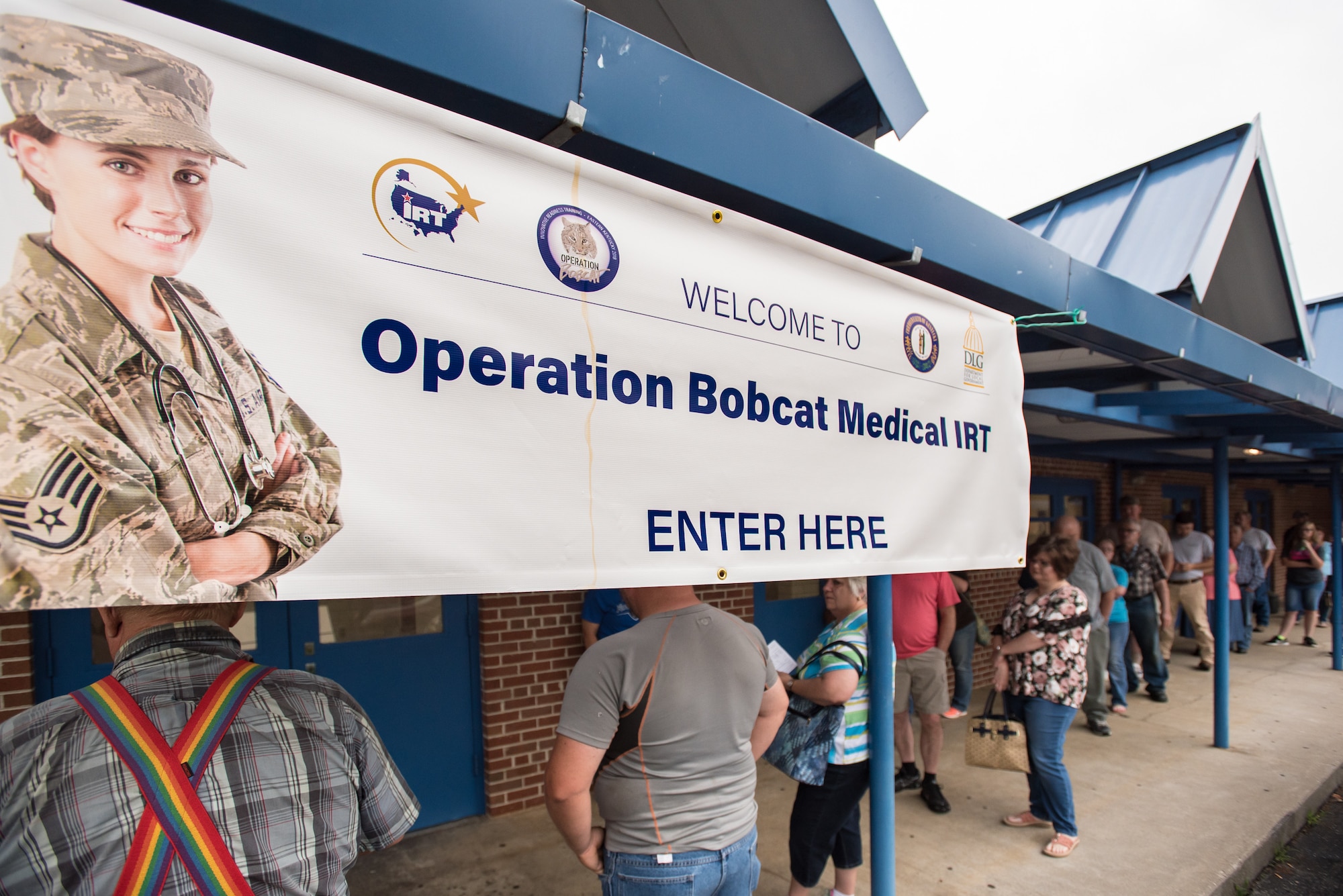 Area residents line up outside Lee County High School in Beattyville, Ky., June 21, 2018, to receive treatment at a health-care clinic being operated by the Air National Guard and U.S. Navy Reserve June 20, 2018. The clinic is one of four that comprised Operation Bobcat, a 10-day mission to provide military medical troops with crucial training in field operations and logistics while offering no-cost health care to the residents of Eastern Kentucky. The clinics, which operated from June 15-24, offered non-emergent medical care; sports physicals; dental cleanings, fillings and extractions; eye exams and no-cost prescription eye glasses. (U.S. Air National Guard photo by Lt. Col. Dale Greer)