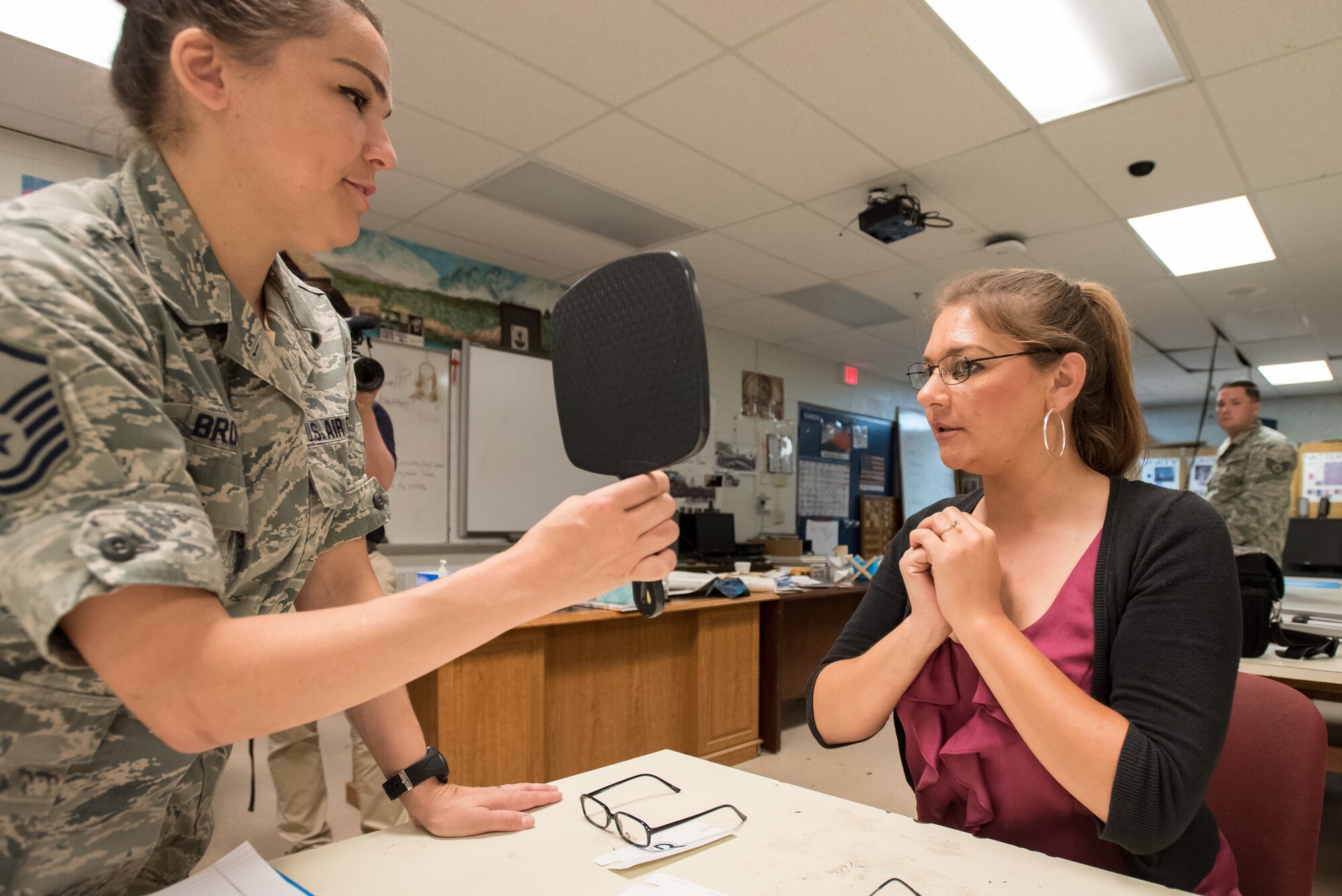 U.S. Air Force Master Sgt. Julie Brown (left), a medic from the Texas Air National Guard’s 136th Airlift Wing, helps Lindsey Howard of Richmond, Ky., select frames for a new pair of eyeglasses at a health-care clinic being operated by the Air Guard and U.S. Navy Reserve at Estill County High School in Irvine, Ky., June 21, 2018. The clinic is one of four that comprised Operation Bobcat, a 10-day mission to provide military medical troops with crucial training in field operations and logistics while offering no-cost health care to the residents of Eastern Kentucky. The clinics, which operated from June 15-24, offered non-emergent medical care; sports physicals; dental cleanings, fillings and extractions; eye exams and no-cost prescription eye glasses. (U.S. Air National Guard photo by Lt. Col. Dale Greer)