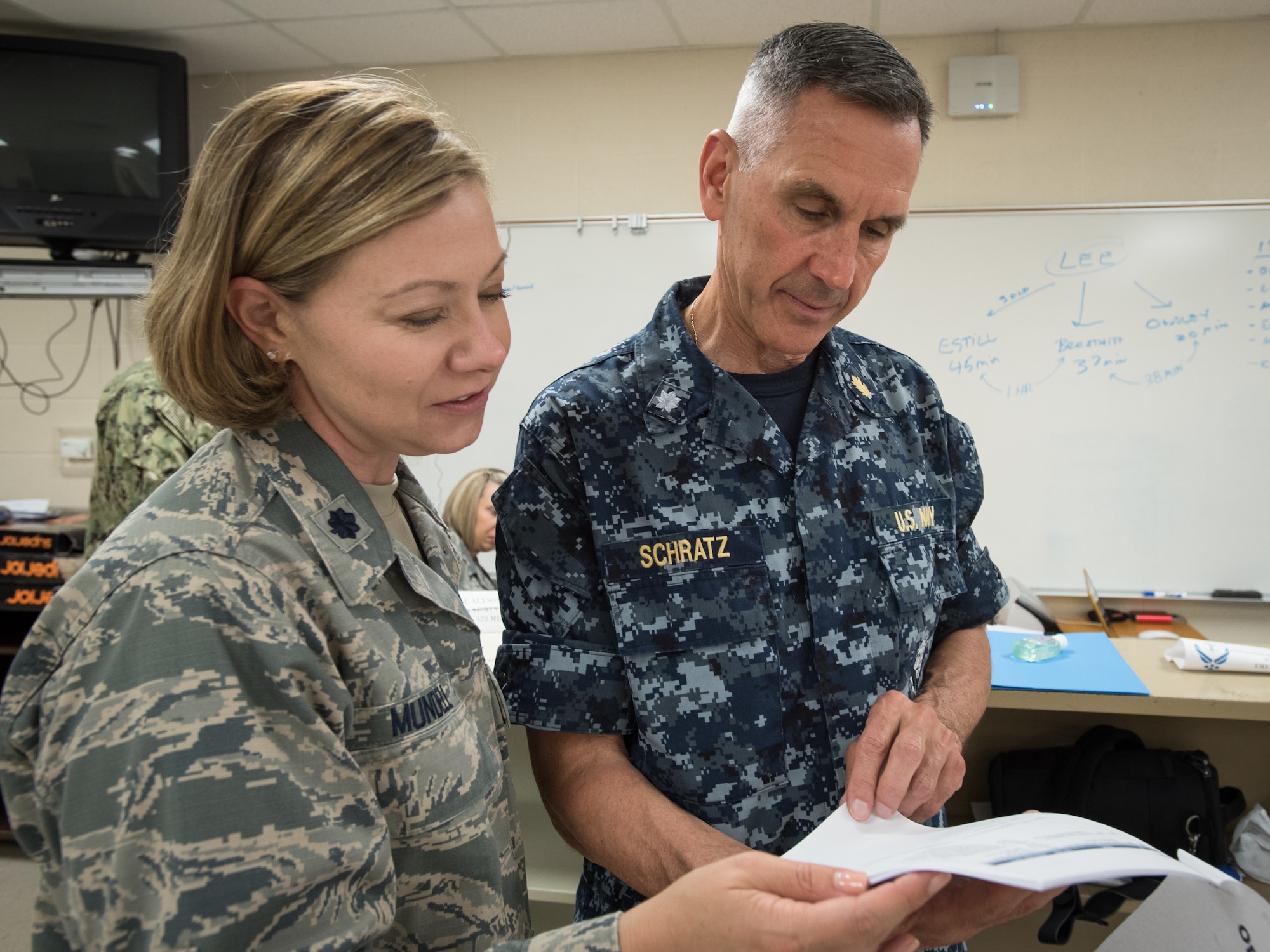 U.S. Air Force Lt. Col. Amy Mundell (left), a medical administrative officer with the Kentucky Air National Guard’s 123rd Airlift Wing, and U.S. Navy Cmdr. Walter Schratz, a dentist from Expeditionary Medical Facility Bethesda in Maryland, discuss remobilization plans at a health-care clinic at Lee County High School in Beattyville, Ky., June 24, 2018. The clinic is one of four that comprised Operation Bobcat, a 10-day mission to provide military medical troops with crucial training in field operations and logistics while offering no-cost health care to the residents of Eastern Kentucky. The clinics, which operated from June 15-24, offered non-emergent medical care; sports physicals; dental cleanings, fillings and extractions; eye exams and no-cost prescription eye glasses. (U.S. Air National Guard photo by Lt. Col. Dale Greer)