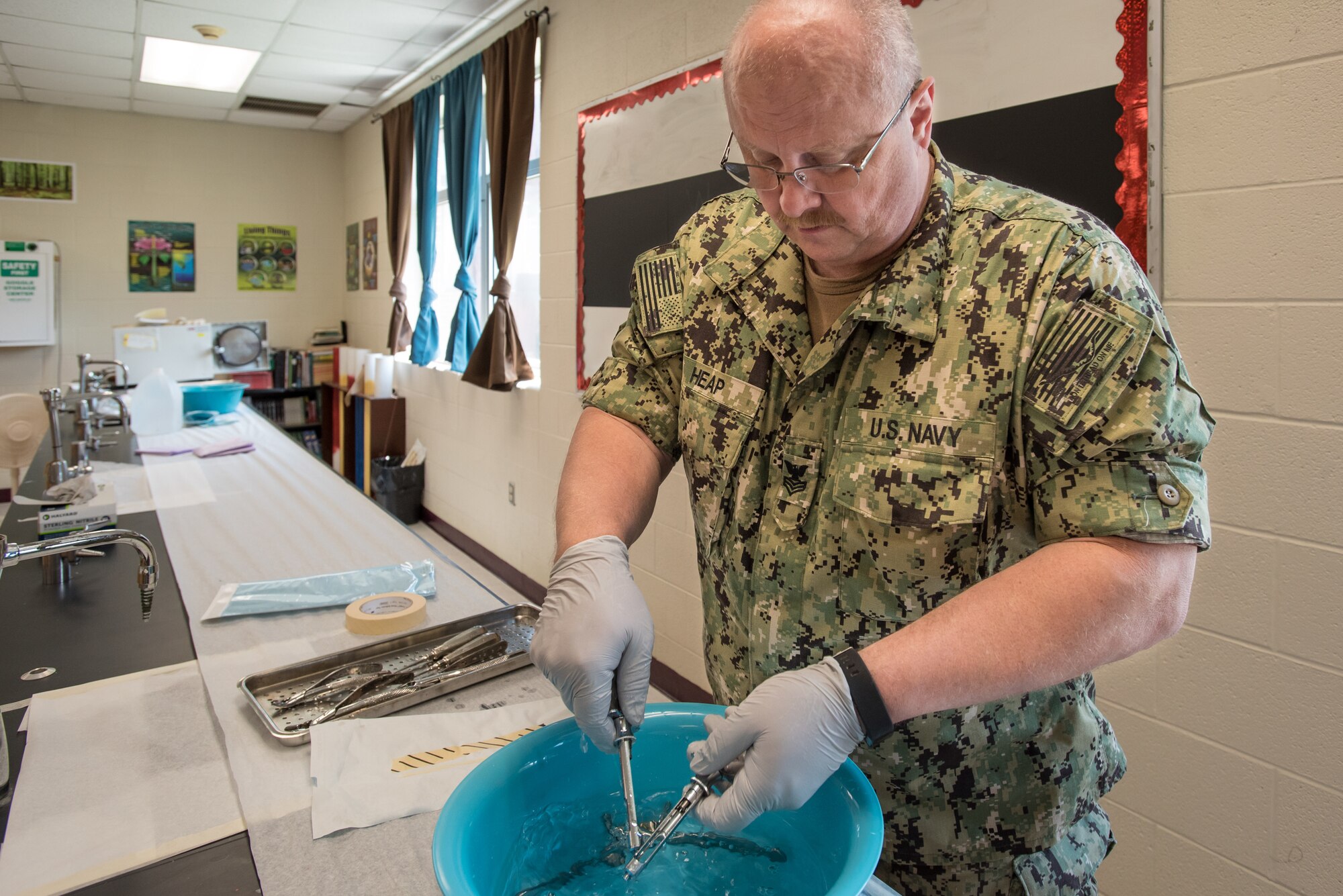 U.S. Navy HM1 Billy Joe Heap, a corpsman from Expeditionary Medical Facility Dallas, sterilizes dental instruments at a health-care clinic at Owsley County High School in Booneville, Ky., June 24, 2018. The clinic is one of four that comprised Operation Bobcat, a 10-day mission to provide military medical troops with crucial training in field operations and logistics while offering no-cost health care to the residents of Eastern Kentucky. The clinics, which operated from June 15-24, offered non-emergent medical care; sports physicals; dental cleanings, fillings and extractions; eye exams and no-cost prescription eye glasses. (U.S. Air National Guard photo by Lt. Col. Dale Greer)