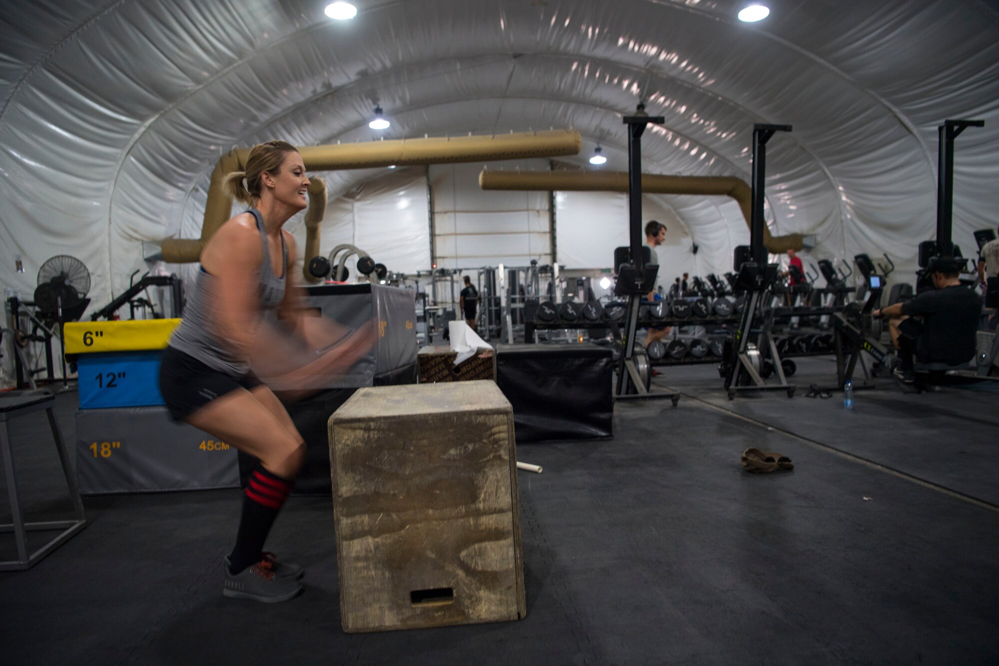 Master Sgt. Nikki Walberg, 386th Air Expeditionary Wing paralegal, executes a box jump during a workout at an undisclosed location in Southwest Asia, June 18, 2018. Walberg works out three times a day in an effort to stay in shape. (U.S. Air Force photo by Staff Sgt. Joshua King)