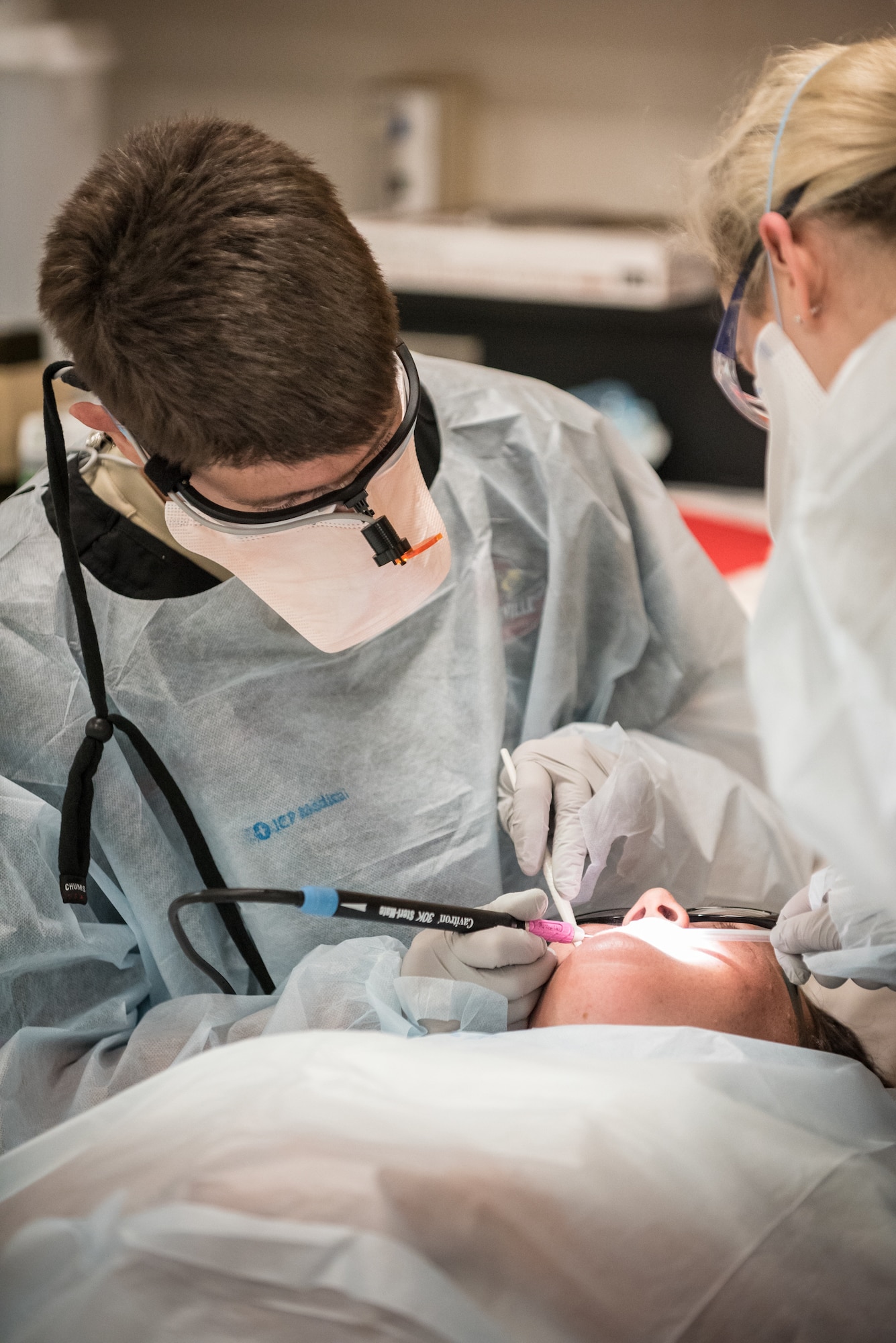U.S. Air Force Maj. Geoffrey Ball, a dentist from the Kentucky Air National Guard’s 123rd Airlift Wing, prepares a patient for a dental filling at a health-care clinic being operated by the Air Guard and U.S. Navy Reserve at Breathitt County High School in Jackson, Ky., June 20, 2018. The Jackson clinic is one of four that comprised Operation Bobcat, a 10-day mission to provide military medical troops with crucial training in field operations and logistics while offering no-cost health care to the residents in Eastern Kentucky. The clinics, which operated from June 15-24, offered non-emergent medical care; sports physicals; dental cleanings, fillings and extractions; eye exams and no-cost prescription eye glasses. (U.S. Air National Guard photo by Lt. Col. Dale Greer)