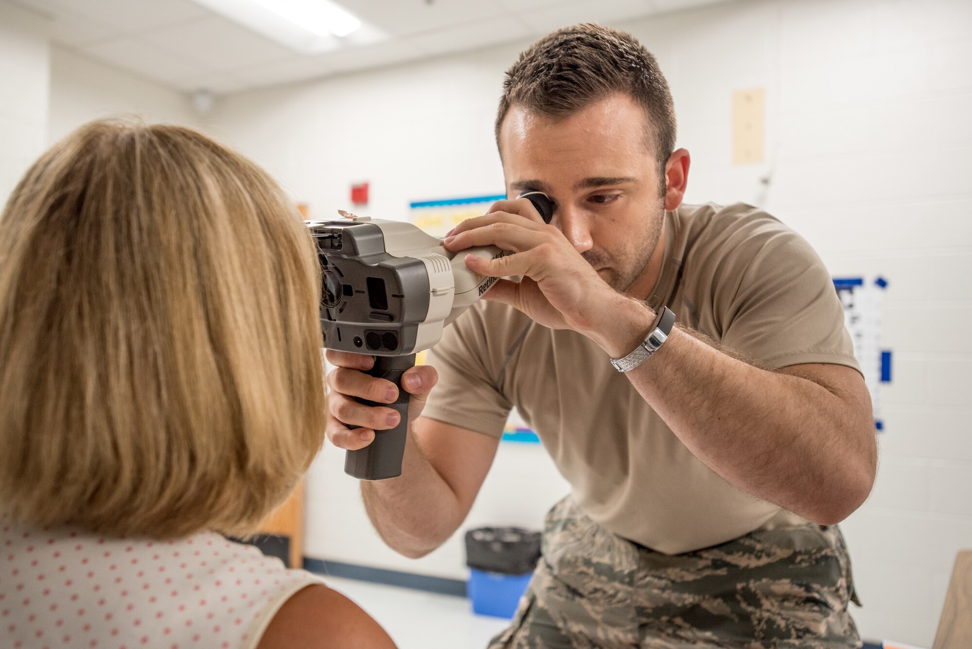 U.S. Air Force Senior Airman Dane Mendelsohn, a medic from the Kentucky Air National Guard’s 123rd Airlift Wing, screens an optometry patient at a health-care clinic being operated by the Air Guard and U.S. Navy Reserve at Breathitt County High School in Jackson, Ky., June 20, 2018. The Jackson clinic is one of four that comprised Operation Bobcat, a 10-day mission to provide military medical troops with crucial training in field operations and logistics while offering no-cost health care to the residents of Eastern Kentucky. The clinics, which operated from June 15-24, offered non-emergent medical care; sports physicals; dental cleanings, fillings and extractions; eye exams and no-cost prescription eye glasses. (U.S. Air National Guard photo by Lt. Col. Dale Greer)