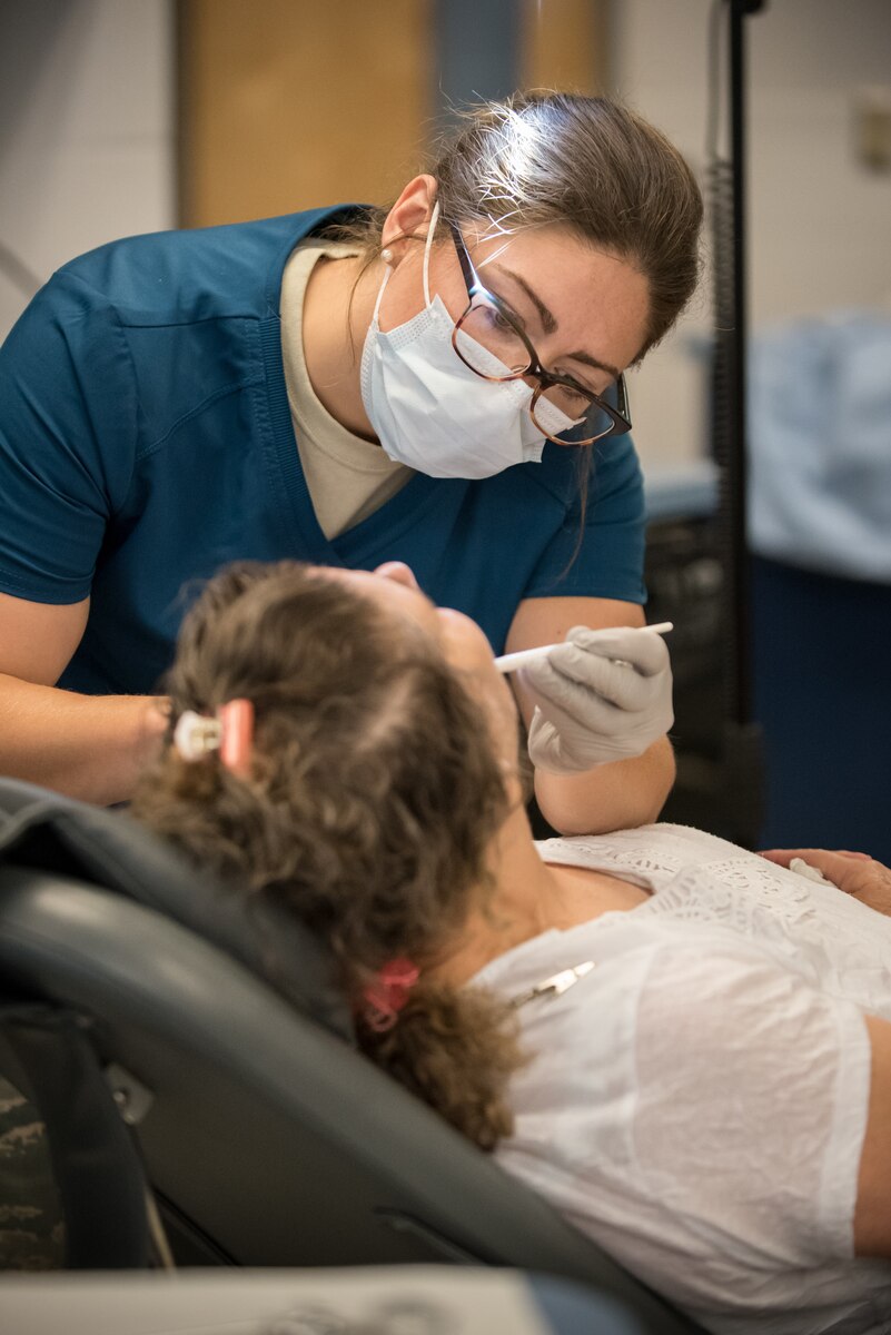 U.S. Air Force Staff Sgt. Elisabeth Runser, a dental technician from the Indiana Air National Guard’s 122nd Air Fighter Wing, cleans a patient’s teeth at a health-care clinic being operated by the Air Guard and U.S. Navy Reserve at Estill County High School in Irvine, Ky., June 21, 2018. The clinic is one of four that comprised Operation Bobcat, a 10-day mission to provide military medical troops with crucial training in field operations and logistics while offering no-cost health care to the residents of Eastern Kentucky. The clinics, which operated from June 15-24, offered non-emergent medical care; sports physicals; dental cleanings, fillings and extractions; eye exams and no-cost prescription eye glasses. (U.S. Air National Guard photo by Lt. Col. Dale Greer)