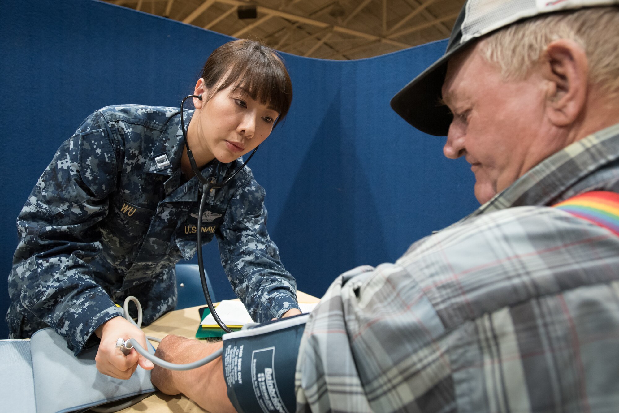 U.S. Navy Lt. Xin Wu, a nurse from Expeditionary Medical Facility Bethesda in Maryland, takes the blood pressure of a patient at a health-care clinic being operated by the Air Guard and U.S. Navy Reserve at Lee County High School in Beattyville, Ky., June 21, 2018. The clinic is one of four that comprised Operation Bobcat, a 10-day mission to provide military medical troops with crucial training in field operations and logistics while offering no-cost health care to the residents of Eastern Kentucky. The clinics, which operated from June 15-24, offered non-emergent medical care; sports physicals; dental cleanings, fillings and extractions; eye exams and no-cost prescription eye glasses. (U.S. Air National Guard photo by Lt. Col. Dale Greer)