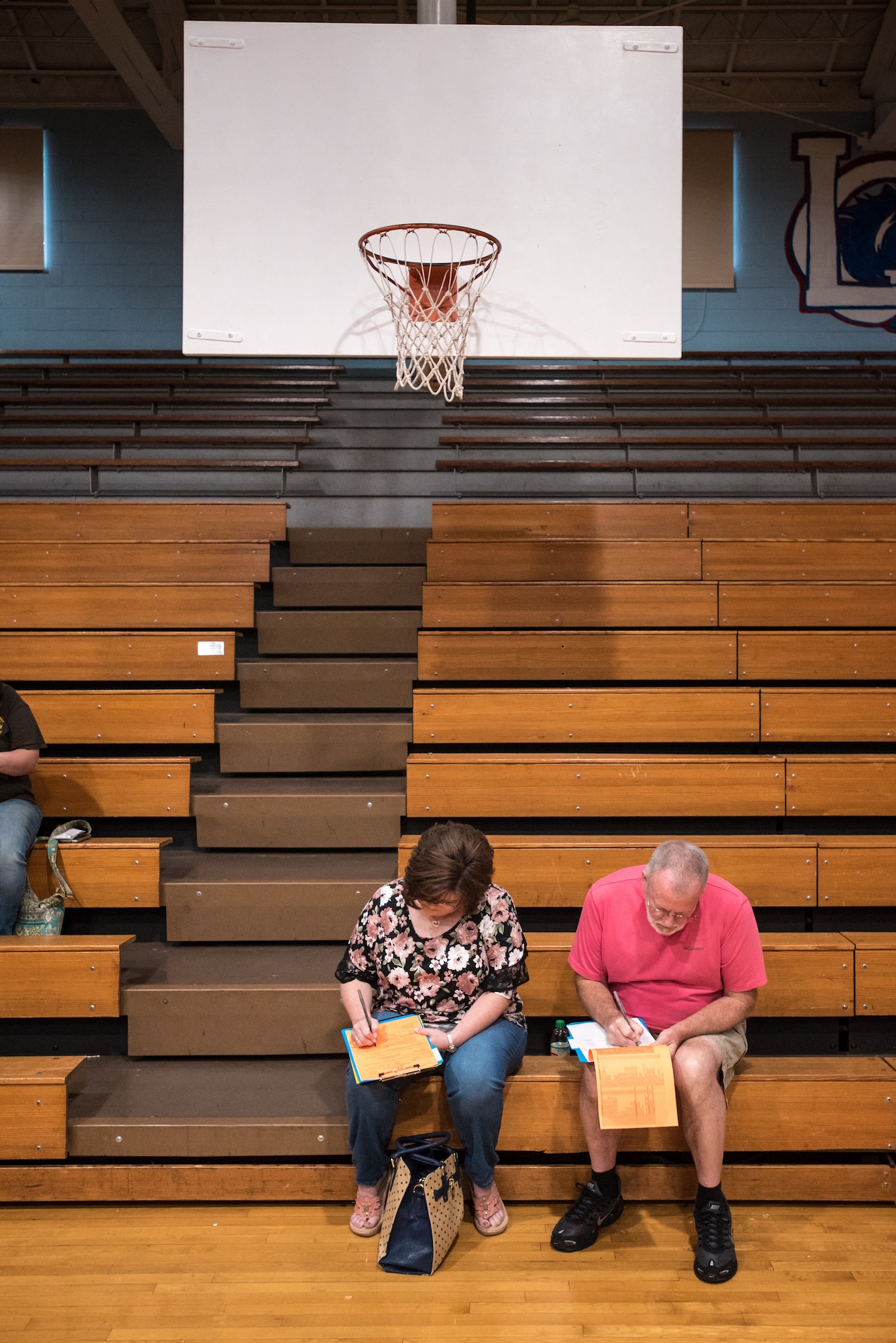Area residents fill our health history forms at Lee County High School in Beattyville, Ky., June 21, 2018, prior to receiving treatment at a clinic being operated by the Air National Guard and U.S. Navy Reserve June 20, 2018. The clinic is one of four that comprised Operation Bobcat, a 10-day mission to provide military medical troops with crucial training in field operations and logistics while offering no-cost health care to the residents of Eastern Kentucky. The clinics, will operated from June 15-24, offered non-emergent medical care; sports physicals; dental cleanings, fillings and extractions; eye exams and no-cost prescription eye glasses. (U.S. Air National Guard photo by Lt. Col. Dale Greer)