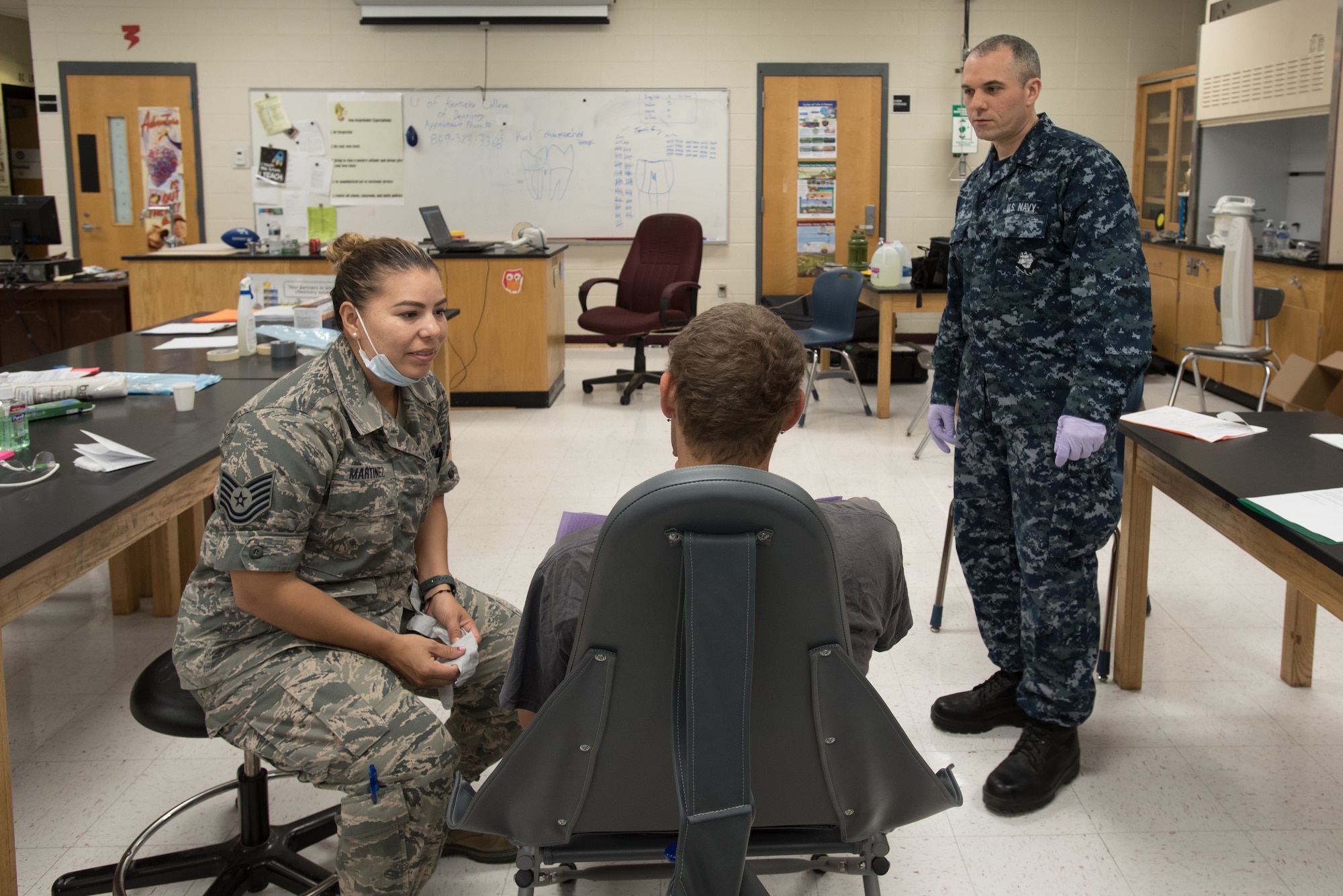 U.S. Air Force Tech. Sgt. Jessica Martinez (left), a dental technician from the Iowa Air National Guard’s 185th Refueling Wing, and U.S. Navy HM3 Jason Dow, a corpsman from Expeditionary Medical Facility Bethesda in Maryland, talk with a dental patient at a health-care clinic at Owsley County High School in Booneville, Ky., June 24, 2018. The clinic is one of four that comprised Operation Bobcat, a 10-day mission to provide military medical troops with crucial training in field operations and logistics while offering no-cost health care to the residents of Eastern Kentucky. The clinics, which operated from June 15-24, offered non-emergent medical care; sports physicals; dental cleanings, fillings and extractions; eye exams and no-cost prescription eye glasses. (U.S. Air National Guard photo by Lt. Col. Dale Greer)
