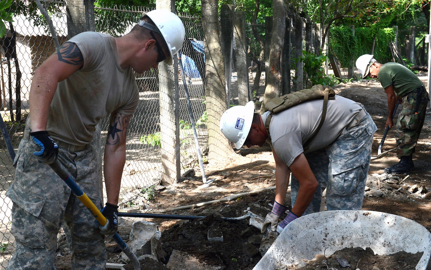 Soldiers from the 4th Engineer Battalion, Fort Carson, Colorado, remove rubble to make way for a sidewalk to a school they are building in rural El Salvador June 23.