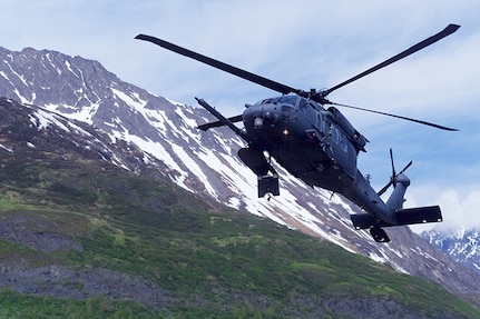 A 210th Rescue Squadron HH-60G Pave Hawk conducts hoist training June 5, 2018, at Eklutna Glacier during a fini flight for Chief Master Sgt. Lance Jordan, command chief master sergeant for the Alaska Air National Guard. A similar helo was involved in the weekend rescue of a critically injured climber.