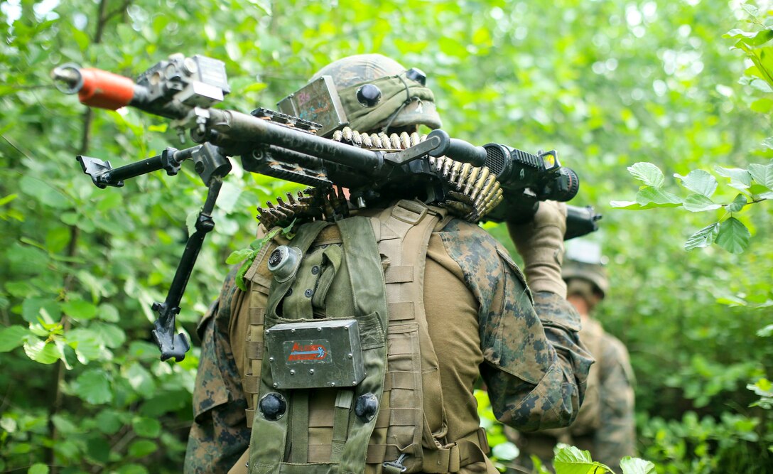 A U.S. Marine from 1st Battalion, 6th Marines maneuvers through a forest during Exercise Saber Strike 18, near Skrunda, Latvia, June 11, 2018. Marines with Black Sea Rotational Force participated in Exercise Saber Strike, which is an integrated field-training exercise that occurs annually throughout Estonia, Latvia, Lithuania and Poland, increasing joint operational capability and enhancing the NATO alliance.