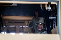 Senior Airman Lormar Rahming, 23d Civil Engineer Squadron (CES) firefighter, looks out of a mine-resistant, ambush-protected vehicle roll-over simulator (MRAP) during tactical convoy operations training, June 21, 2018, at Moody Air Force Base, Ga. For the first time at Moody, 820th Base Defense Group personnel equipped 23d CES Airmen with convoy operations skills to efficiently perform MRAP evacuations. (U.S. Air Force photo by Airman 1st Class Eugene Oliver)