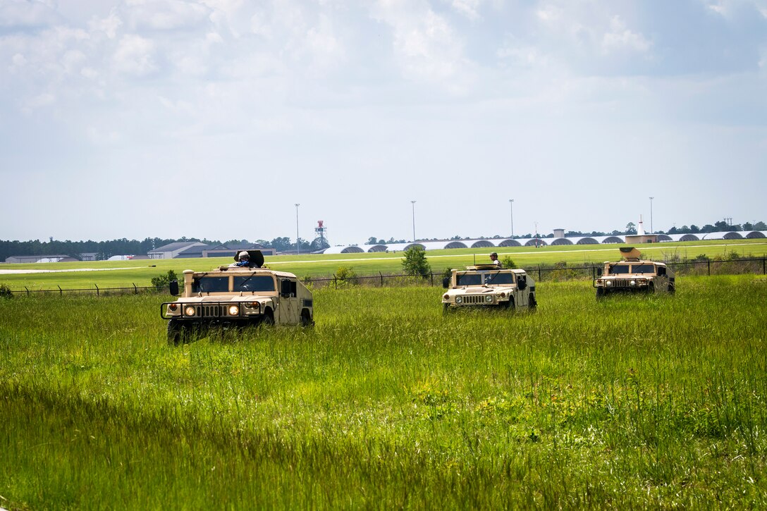 Airmen from the 23d Civil Engineer Squadron (CES), ride in Humvees during tactical convoy operations training, June 21, 2018, at Moody Air Force Base, Ga. For the first time at Moody, 820th Base Defense Group personnel equipped 23d CES Airmen with convoy operations skills to efficiently perform mine-resistant, ambush-protected vehicle roll-over simulator evacuations. (U.S. Air Force photo by Airman 1st Class Eugene Oliver)