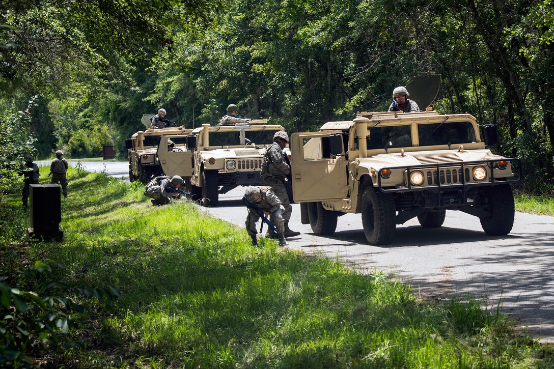 Airmen from the 23d Civil Engineer Squadron (CES) inspect the underbelly of Humvees during tactical convoy operations training, June 21, 2018, at Moody Air Force Base, Ga. For the first time at Moody, 820th Base Defense Group personnel equipped 23d CES Airmen with convoy operations skills to efficiently perform mine-resistant, ambush-protected vehicle roll-over simulator evacuations. (U.S. Air Force photo by Airman 1st Class Eugene Oliver)