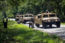 Airmen from the 23d Civil Engineer Squadron (CES) inspect the underbelly of Humvees during tactical convoy operations training, June 21, 2018, at Moody Air Force Base, Ga. For the first time at Moody, 820th Base Defense Group personnel equipped 23d CES Airmen with convoy operations skills to efficiently perform mine-resistant, ambush-protected vehicle roll-over simulator evacuations. (U.S. Air Force photo by Airman 1st Class Eugene Oliver)