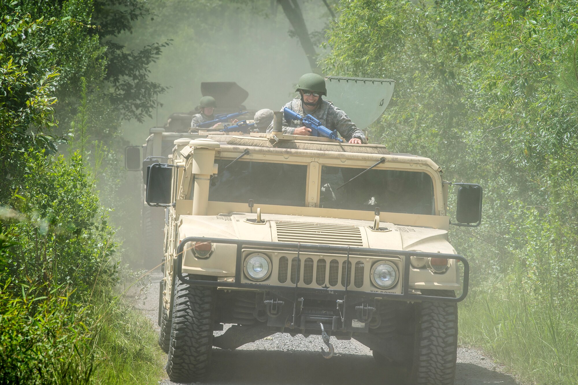 Airmen from the 23d Civil Engineer Squadron (CES) ride in Humvees during tactical convoy operations training, June 21, 2018, at Moody Air Force Base, Ga. For the first time at Moody, 820th Base Defense Group personnel equipped 23d CES Airmen with convoy operations skills to efficiently perform mine-resistant, ambush-protected vehicle roll-over simulator evacuations. (U.S. Air Force photo by Airman 1st Class Eugene Oliver)