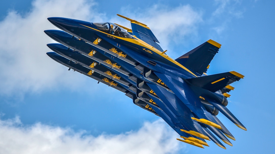 Four aircraft fly in tight formation.