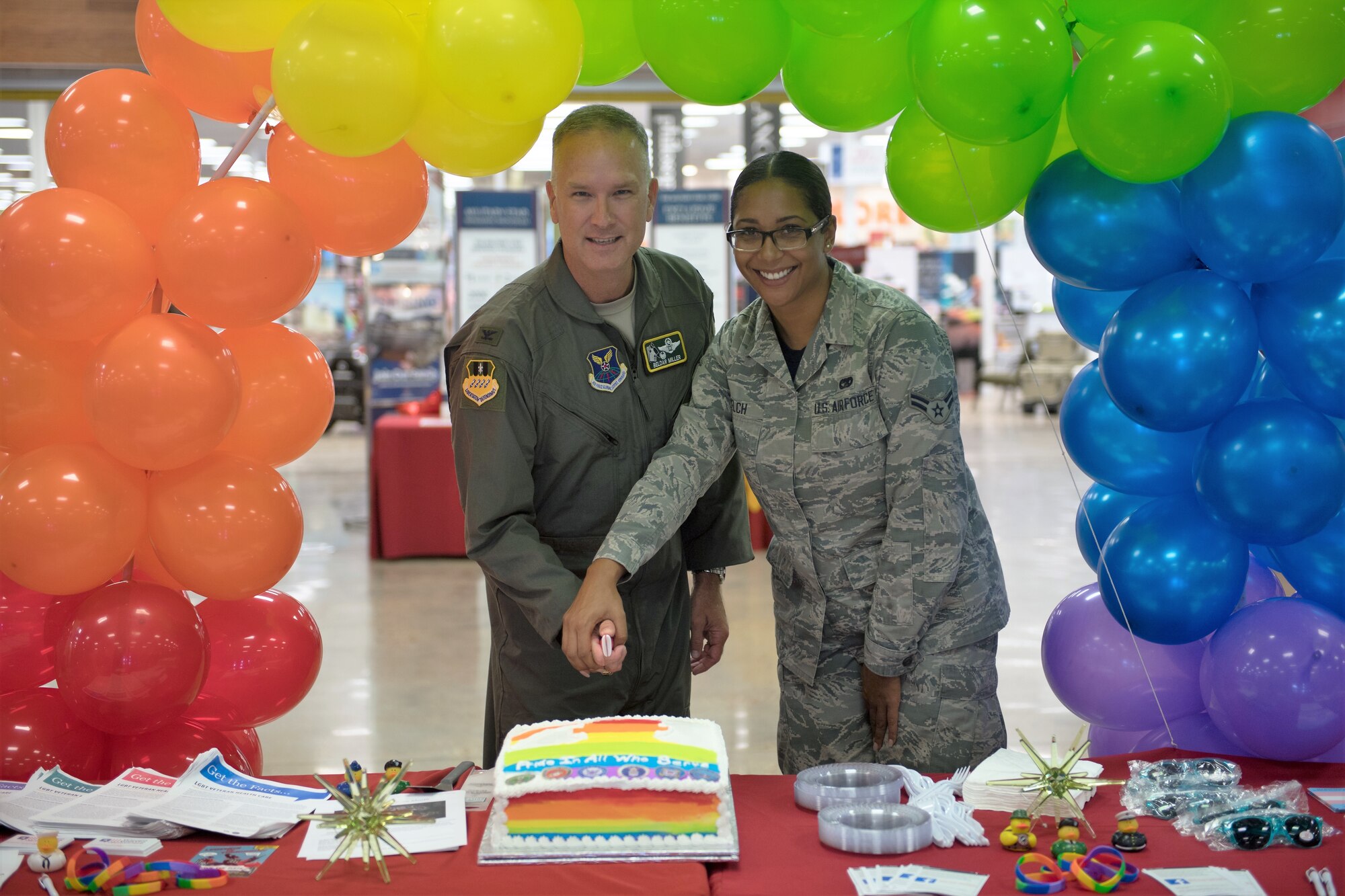 Col. Michael Miller, 2nd Bomb Wing commander, and Airman 1st Class Wenona Welch, 2nd Logistics Readiness Squadron, cut a cake during Barksdale's LGBT Pride Month observance event, June 22, 2018. (U.S. Air Force photo by Tech. Sgt. Daniel Martinez)
