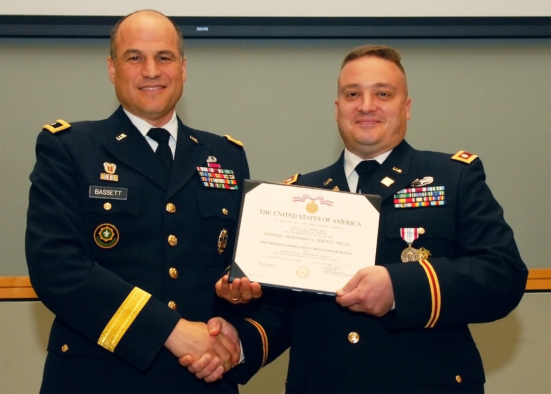 Army Maj. Gen. David G. Bassett congratulates Army Lt. Col. Paul V. McCullough III during his retirement ceremony June 21. McCullough retired with 20 years of military service.