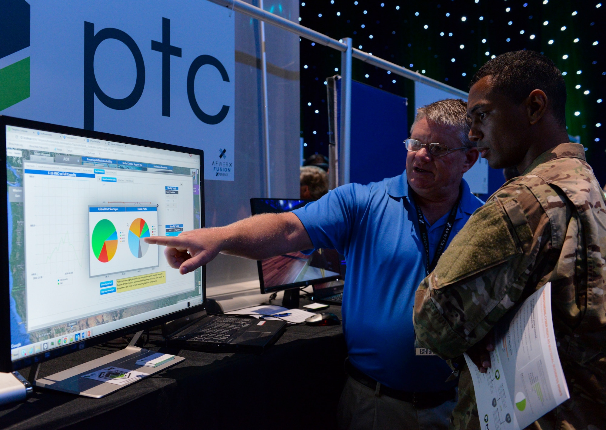 Todd Stecker, exhibitor for PTC, presents his innovative perimeter security ideas to Airman 1st Class Michael Hickson, client system technician assigned to the 353 Special Operations Support Squadron at Kadena Air Base, Japan, at the AFWERX Fusion Experience event in Las Vegas June 20, 2018. Personnel across the Air Force were invited to the event to learn more about instilling a culture of innovation within the military and beyond through a series of presentations, panels and workshops dedicated to perimeter security. (U.S. Air Force photo by Airman Bailee A. Darbasie)