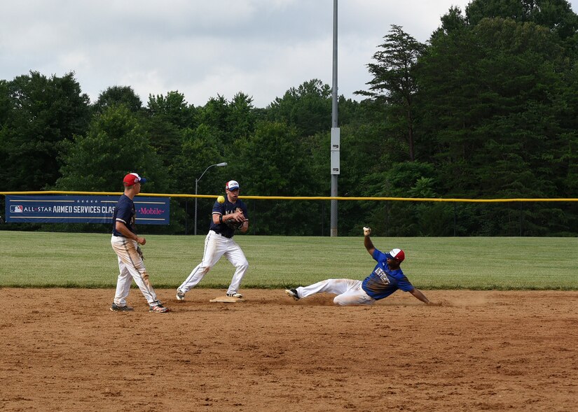 Master Sgt. Jamal Nails, National Capital Region Air Force softball team third baseman, slides into second base during the preliminary round of the Armed Services Classic softball tournament at Jericho Park in Bowie, Md., June 23, 2018. After the preliminary games, the top two teams in the tournament go on to compete in a championship game as part of Major League Baseball’s All-Star Week. (U.S. Air Force photo by Senior Airman Abby L. Richardson)