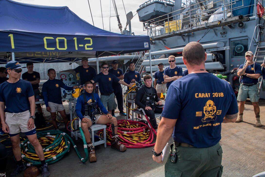 U.S. and Royal Thai Navy divers receive a mission and safety briefing.