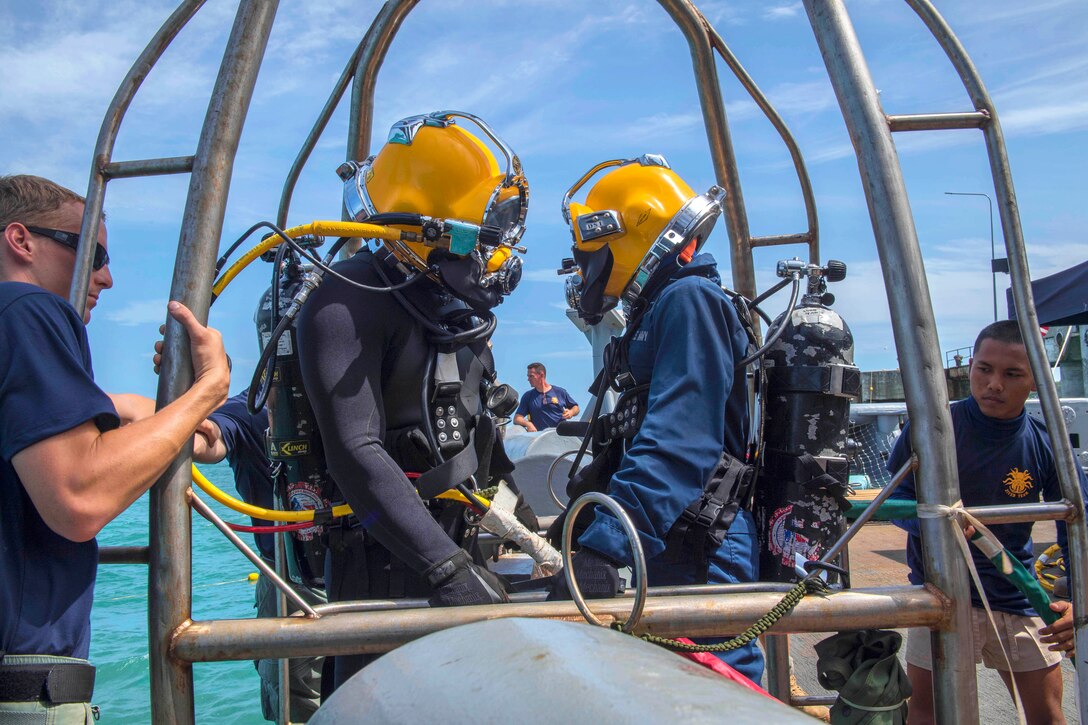 A U.S. Navy diver, left, and a Royal Thai navy diver prepare to conduct a joint dive training.