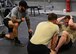 Adam DeRycke, a Survival, Evasion, Resistance and Escape Specialist Training Orientation Course instructor and training manager, at left, monitors the performance of candidates during a mock physical fitness assessment at the SERE specialist schoolhouse at Joint Base San Antonio-Lackland, Texas, March 22, 2018. Candidates are critiqued on physical training, backpacking, basic public speaking, outdoor living and survival skills and improvising to assess their potential success as a future SERE specialist. (U.S. Air Force photo by Staff Sgt. Chip Pons)