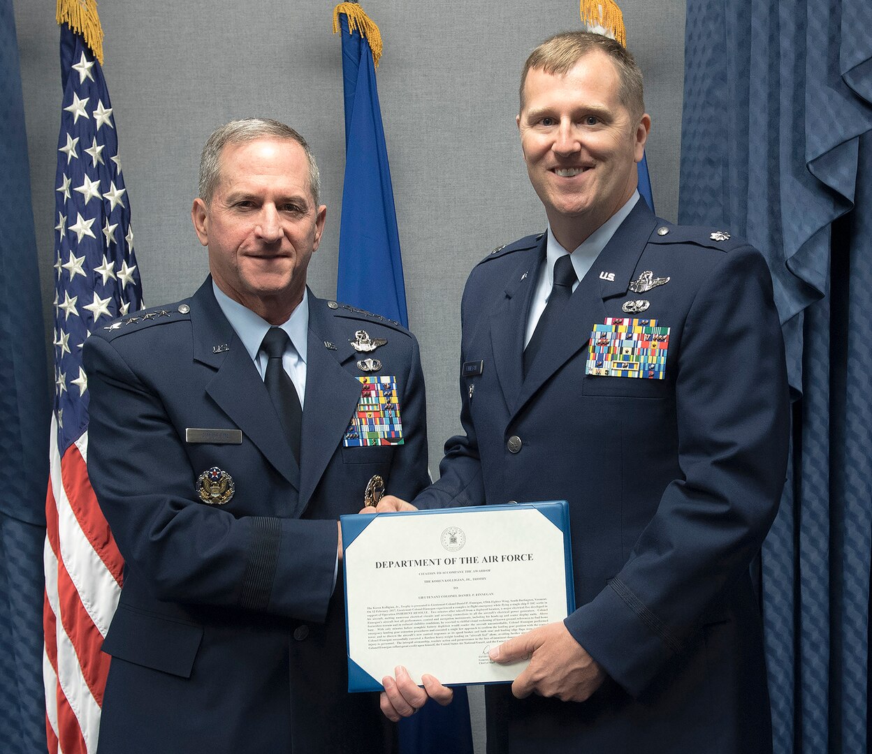 Lt. Col Daniel Finnegan receives the Koren Kolligian Trophy certificate from Air Force Chief of Staff Gen. David L. Goldfein in the Pentagon, Arlington, Va., June 25, 2018. (U.S. Air Force photo by Wayne A. Clark)