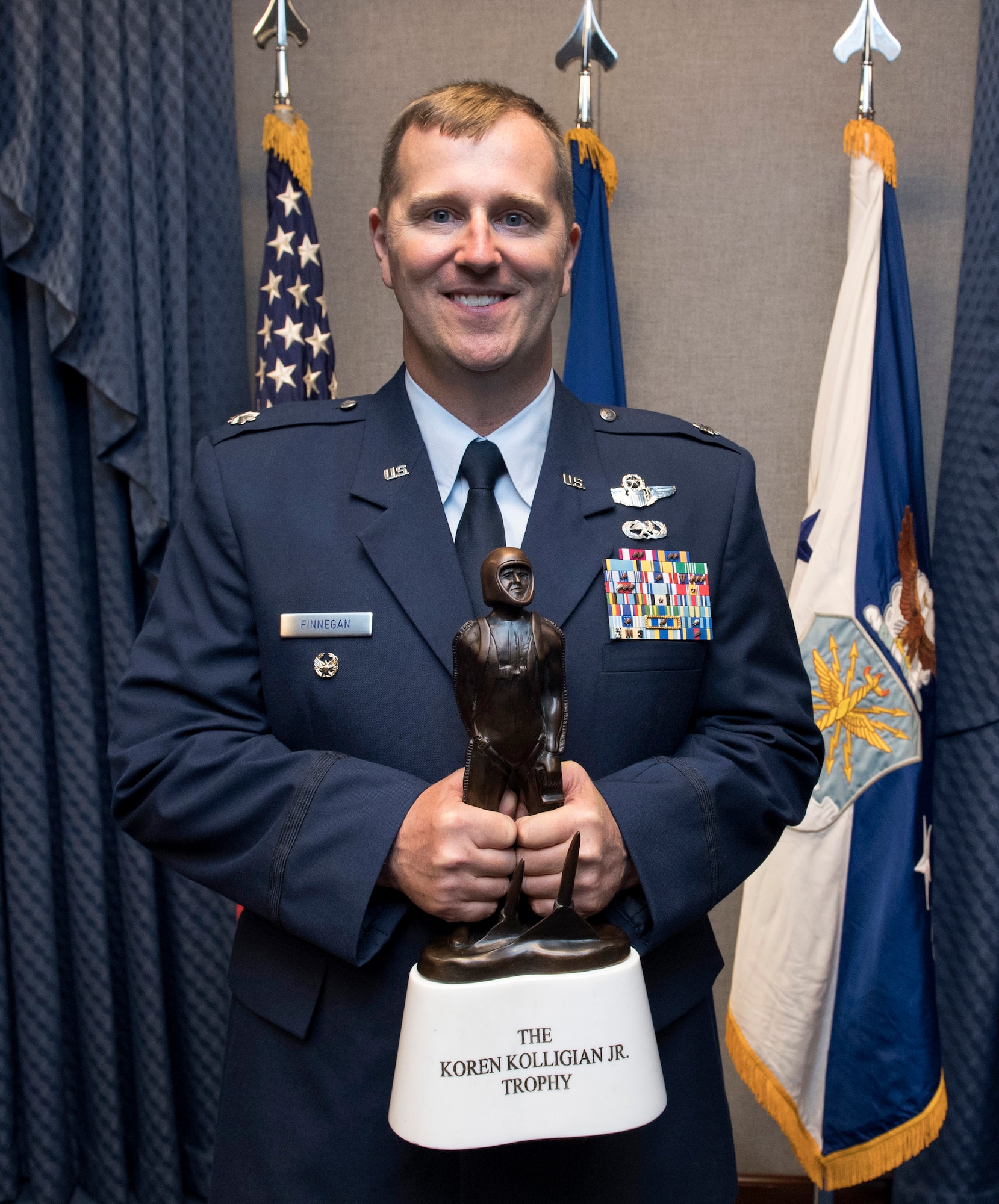 Lt. Col Daniel Finnegan holds the Koren Kolligian Trophy during a ceremony in the Pentagon, Arlington, Va., June 25, 2018. (U.S. Air Force photo by Wayne A. Clark)