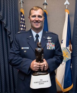 Lt. Col Daniel Finnegan holds the Koren Kolligian Trophy during a ceremony in the Pentagon, Arlington, Va., June 25, 2018. (U.S. Air Force photo by Wayne A. Clark)