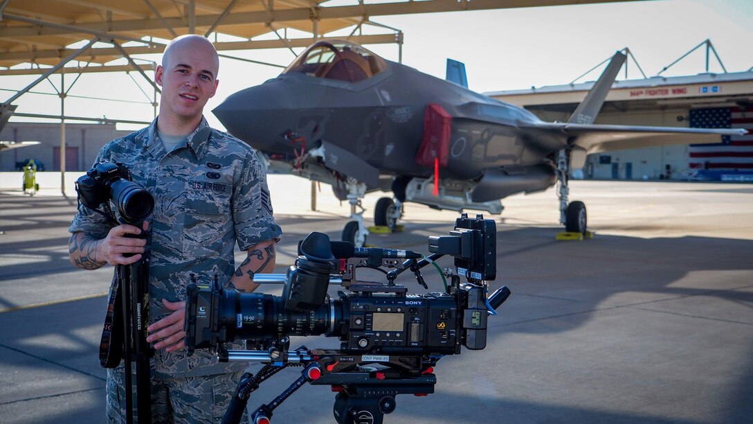 Airman prepares cameras for production shoot.