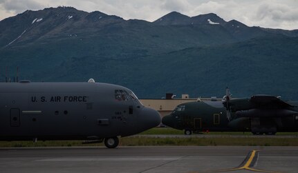 U.S. Air Force C-130J Super Hercules aircraft from Yokota Air Base, Japan, and Japan Air Self-Defense Force C-130H Hercules aircraft from Hamamatsu Air Base, Japan, prepare for takeoff during Red Flag-Alaska 18-2 operations at Joint Base Elmendorf-Richardson, Alaska, June 21, 2018. RF-A is Pacific Air Forces’ premier air combat exercise that provides joint offensive counter-air, interdiction, close air support and large force employment training in a simulated combat environment.