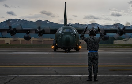A Japan Air Self-Defense Force Airman marshals a JASDF C-130H Hercules aircraft from Hamamatsu Air Base, Japan, prior to takeoff during Red Flag-Alaska 18-2 operations at Joint Base Elmendorf-Richardson, Alaska, June 21, 2018. Seventy-seven JASDF Airmen operated out of JBER for Pacific Air Forces’ premier air combat exercise. Since its inception, thousands of service members from all branches of the U.S. military, as well as armed services of multiple countries from around the world, have taken part in Red Flag-Alaska.